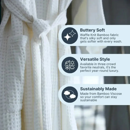 White waffle knit bamboo robe hanging, featuring buttery soft, sustainable fabric and pockets.