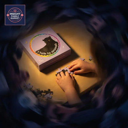 Child assembling animal puzzle pieces at a table with 'I talk to animals' puzzle box.