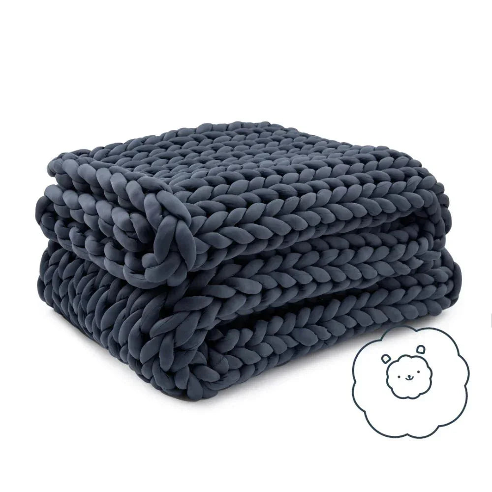 Dark grey chunky knit cooling weighted blanket neatly folded on white background with a cute sheep icon.