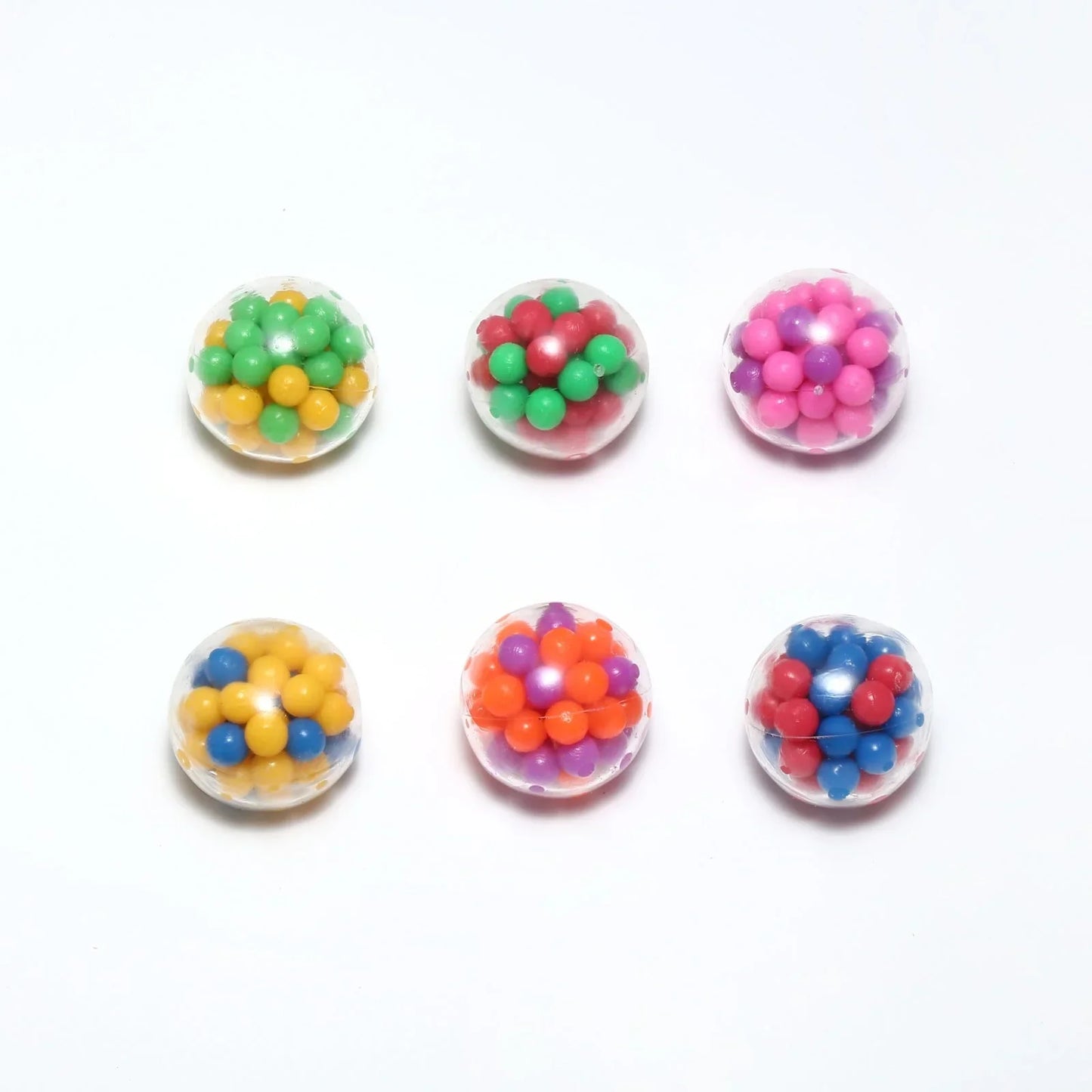Six colorful sensory fidget balls with beads for stress relief on a white background