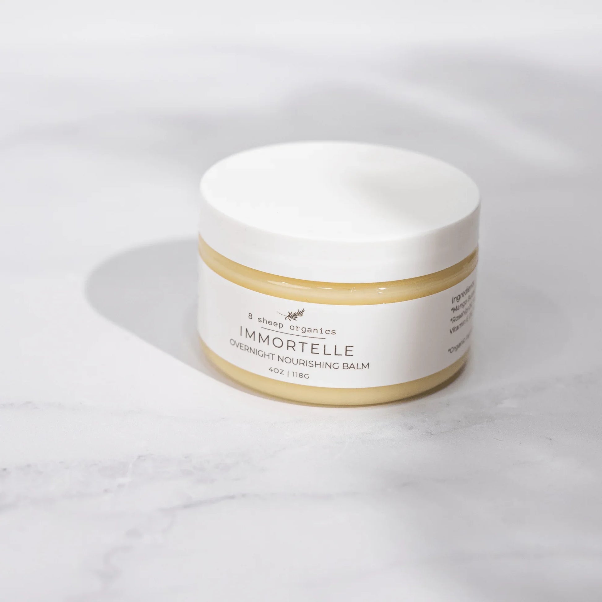 8 Sheep Organics Immortelle Overnight Nourishing Balm jar on a marble surface