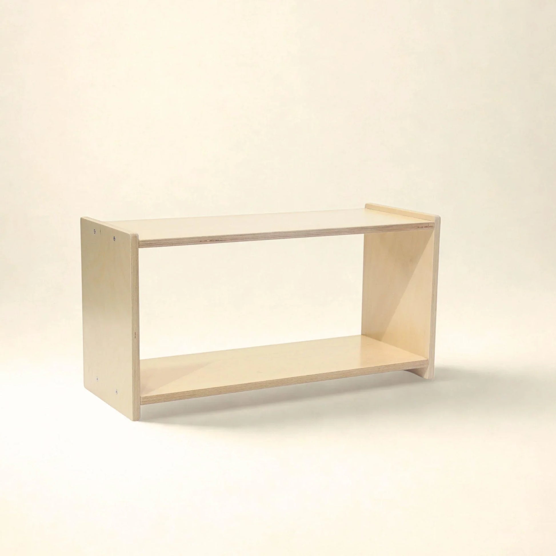 Natural wood Montessori infant shelf with open two-level design on a neutral background