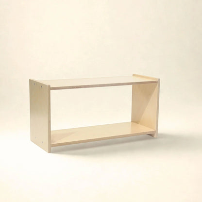 Natural wood Montessori infant shelf with open two-level design on a neutral background