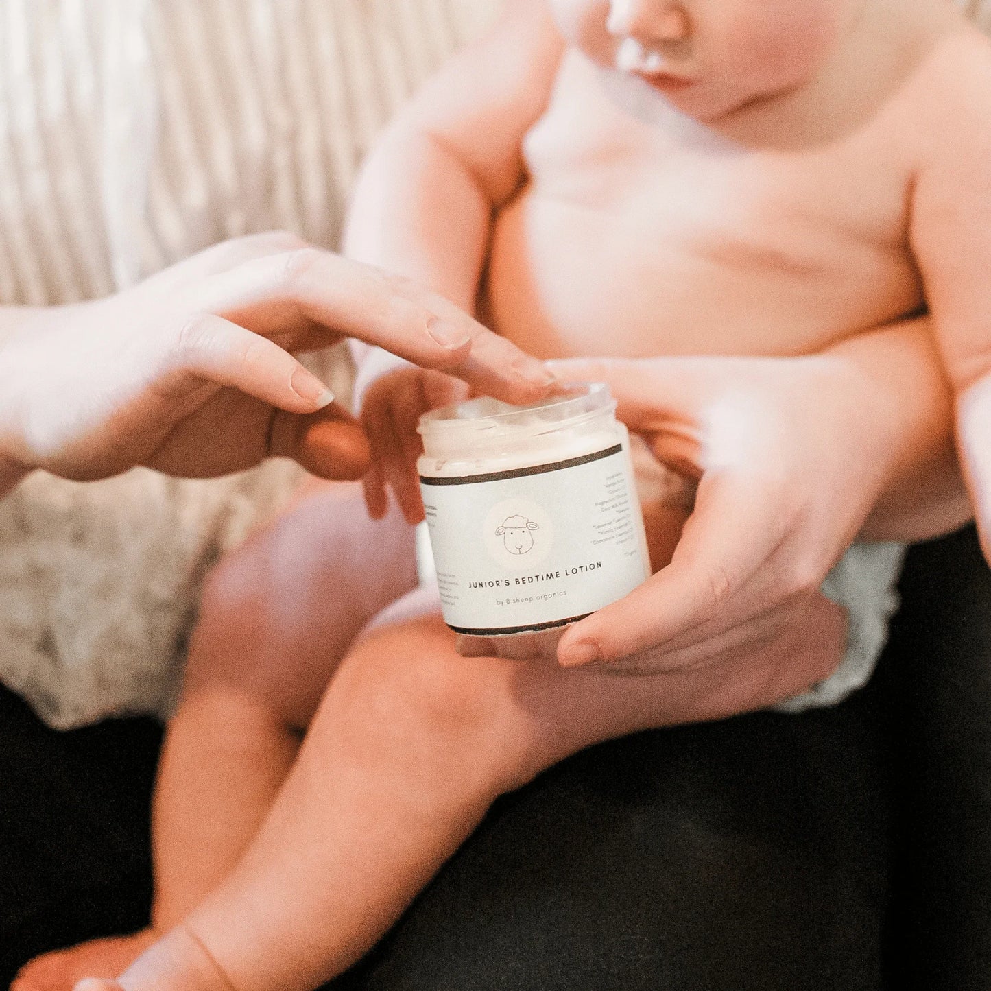 Parent applying Junior's Bedtime Lotion to baby, gentle sleep support skincare