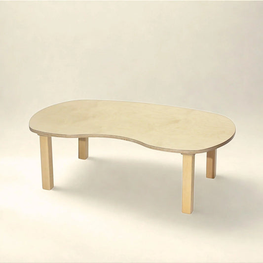 Kidney-shaped wooden toddler sensory table with light wood finish in a neutral setting