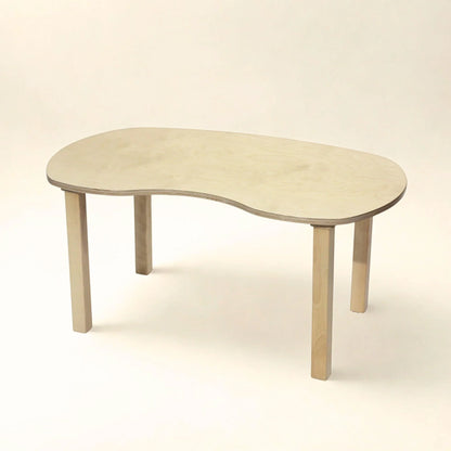 Light wood kidney-shaped preschool table with four sturdy legs on a white background