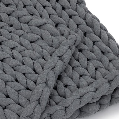 Close-up of chunky knit gray weighted blanket, soft sensory-friendly fabric