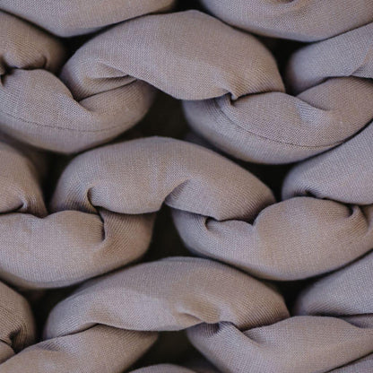 Close-up of dusty rose chunky knit sensory blanket, soft braided cotton texture