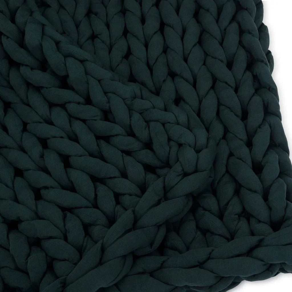 Closeup of chunky knit forest green sensory-friendly weighted blanket