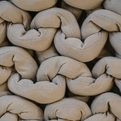 Closeup of chunky knit taupe sensory blanket, soft textured woven fabric