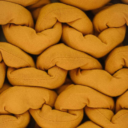 Closeup of chunky knitted mustard yellow sensory-friendly fabric