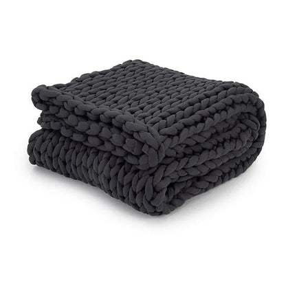 Folded chunky knit charcoal weighted blanket for sensory support