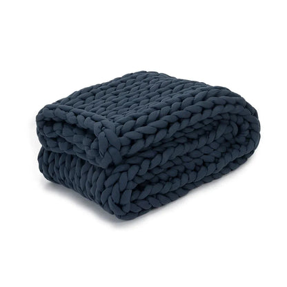Folded chunky knit dark blue weighted blanket for sensory support