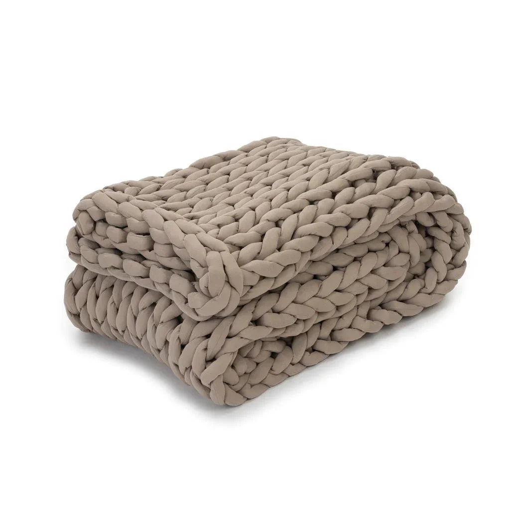 Folded taupe chunky knit weighted blanket for sensory support on white background