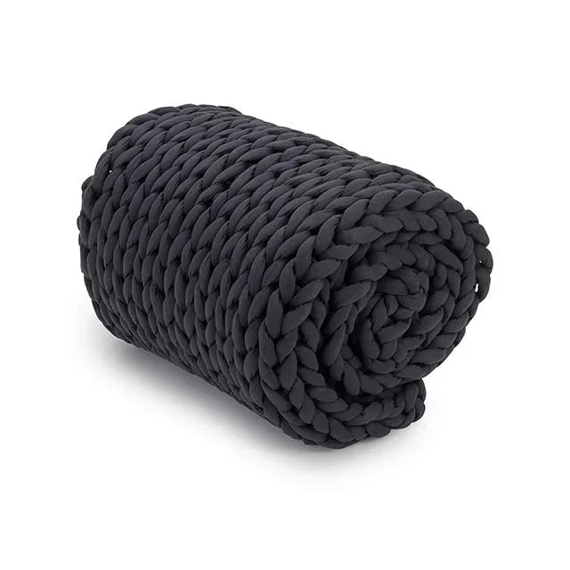Rolled chunky knit charcoal weighted blanket on a white background