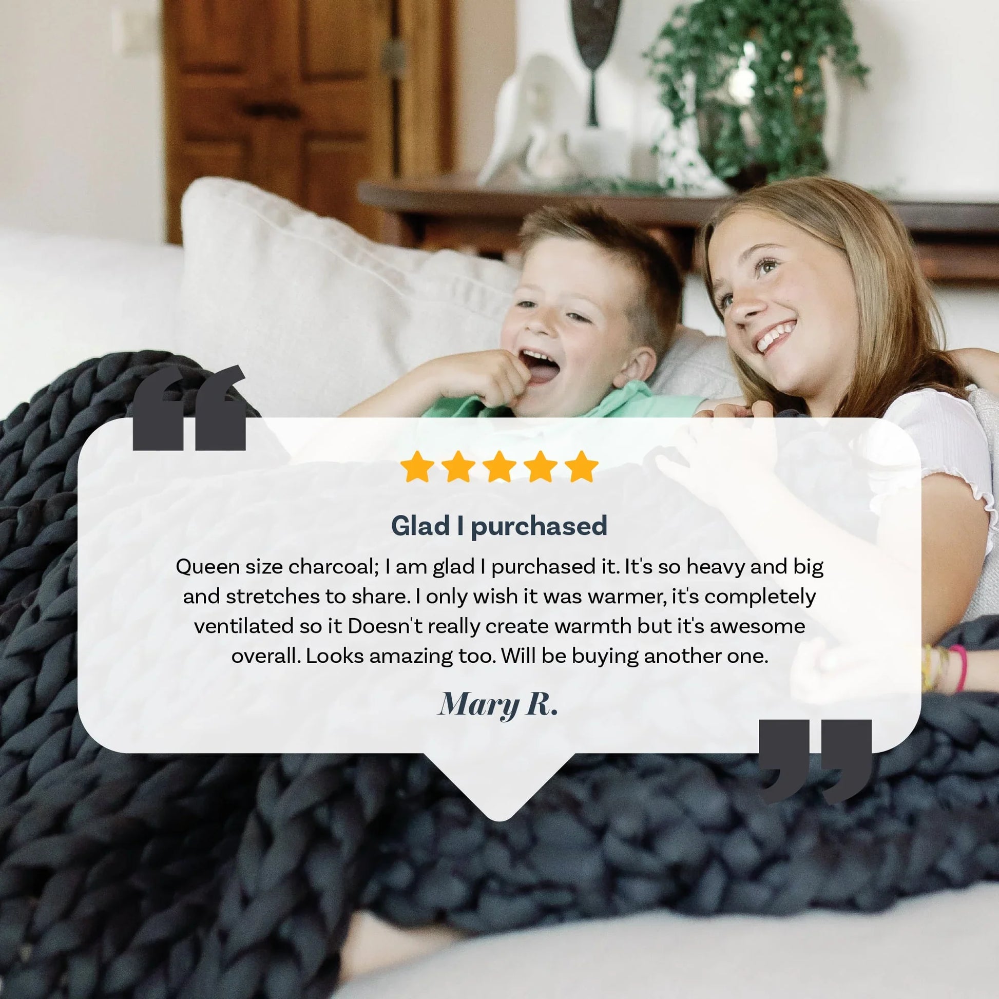 Smiling children relaxing under a chunky charcoal weighted blanket on a couch, product review overlayed.