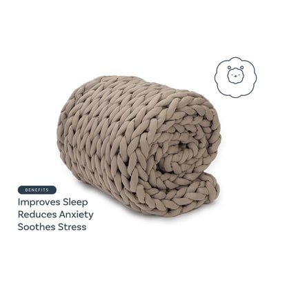 Taupe chunky knit weighted blanket rolled up, with benefits text: improves sleep, reduces anxiety, soothes stress.