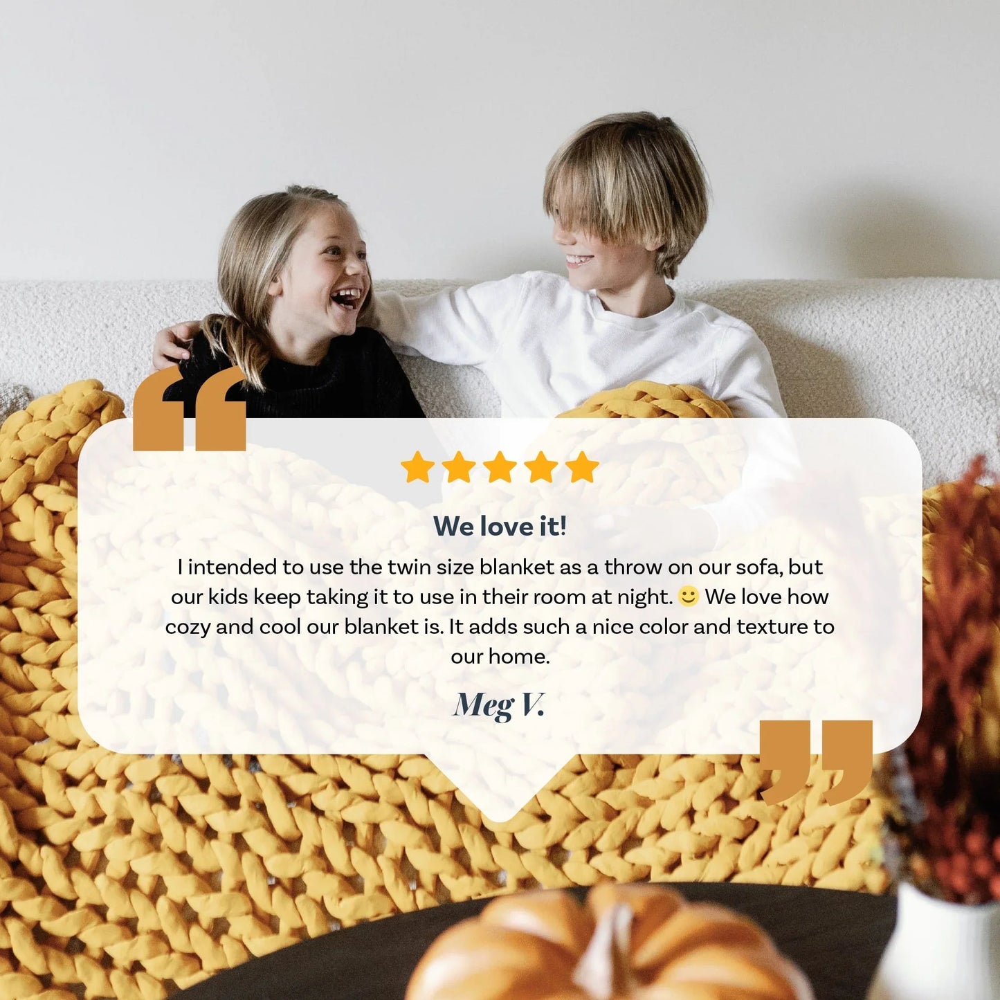 Two kids smiling on a sofa with a chunky yellow knit weighted blanket and testimonial overlay.