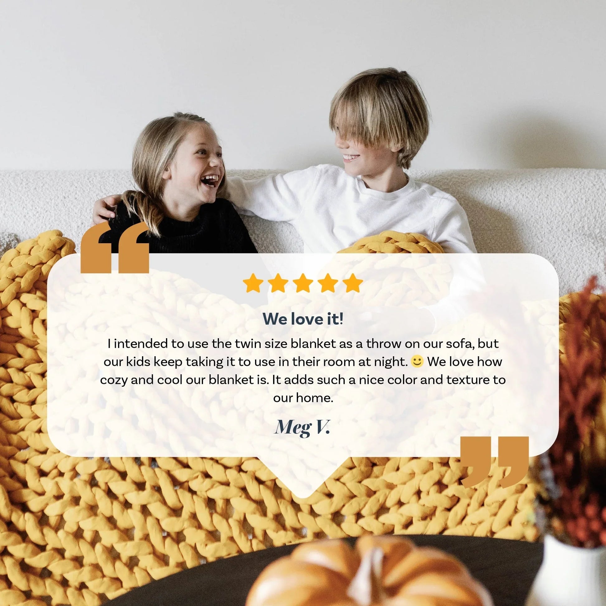 Two kids smiling on a sofa with a chunky yellow knit weighted blanket and testimonial overlay.