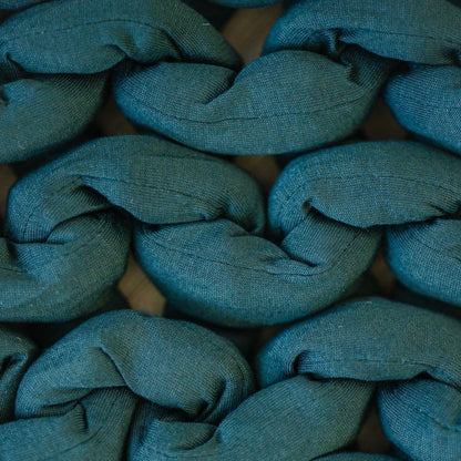 closeup of chunky forest green sensory blanket with soft textured knit fabric