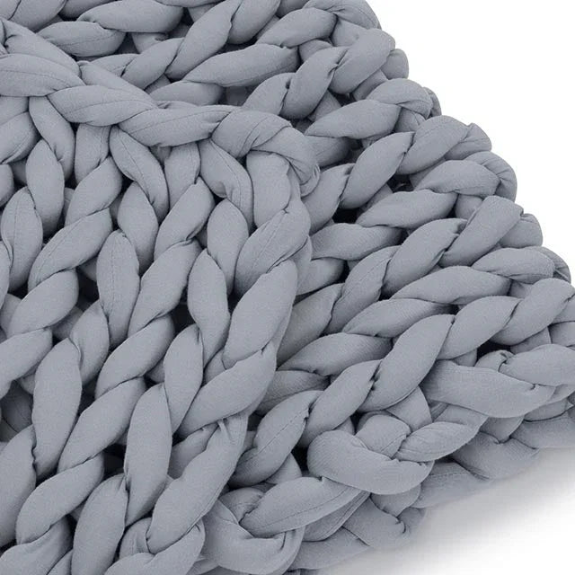 closeup of chunky knit light gray weighted blanket, sensory-friendly fabric texture