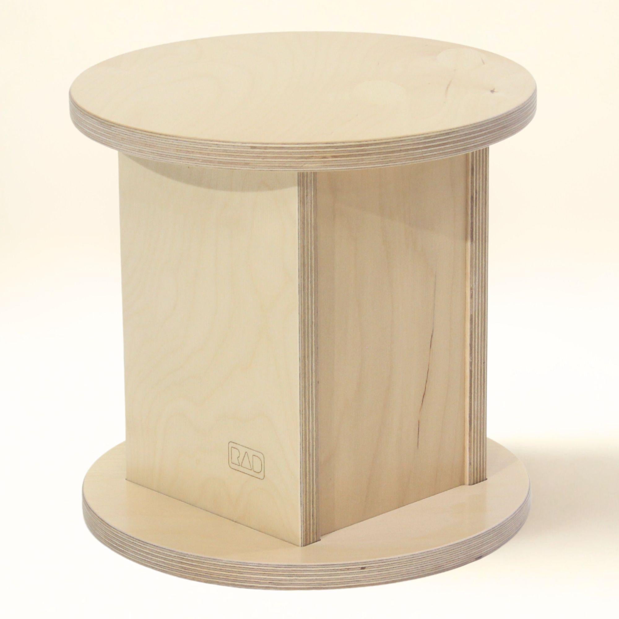 Wooden stool with a round top and cylindrical base on a white background
