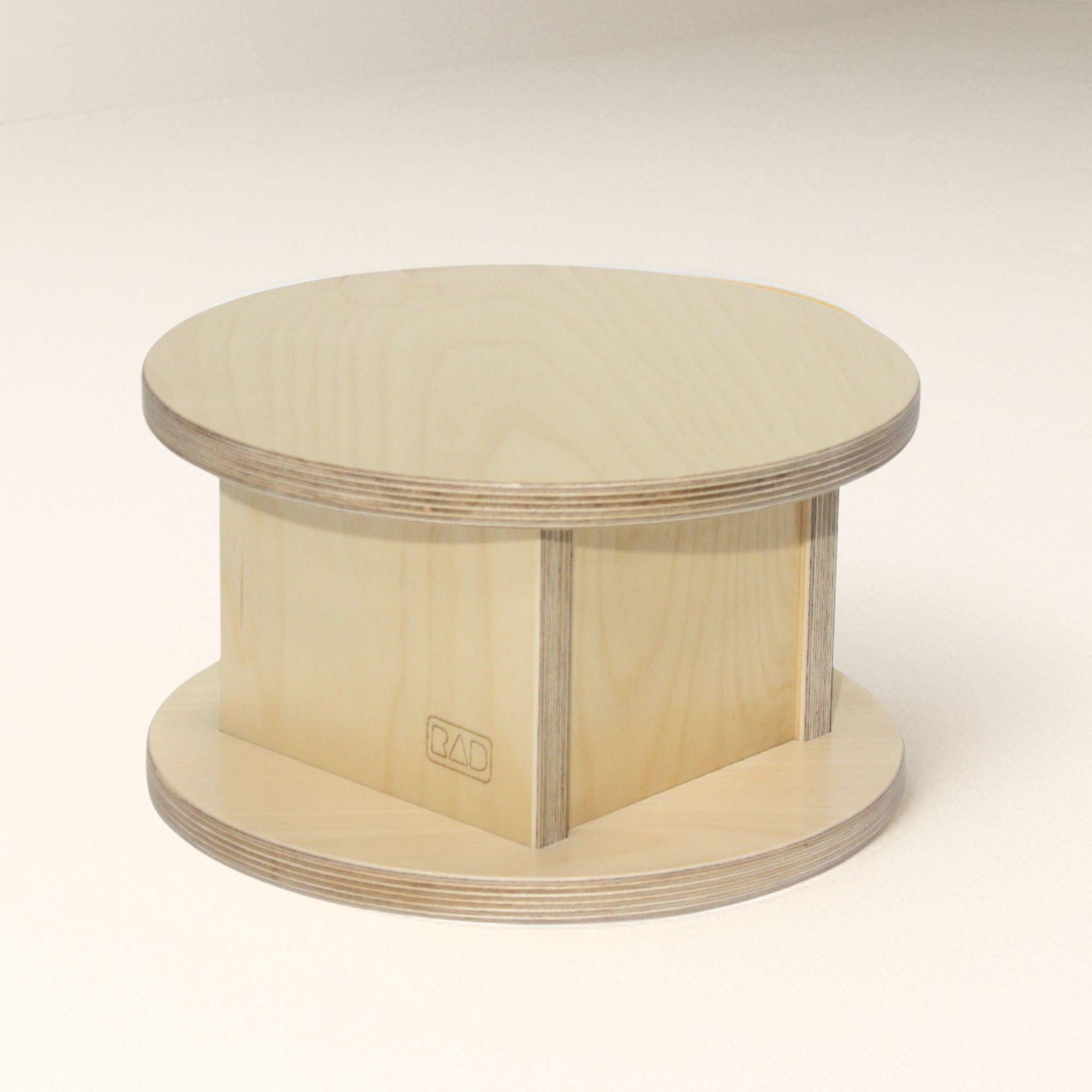 Round wooden platform with a visible brand logo on a white background