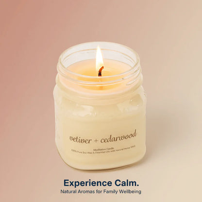 Lit vetiver and cedarwood meditation candle in glass jar, natural soy wax, calming aroma.