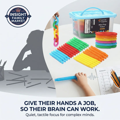 Child using colorful sensory pop tubes for focus beside homework and a storage bin.