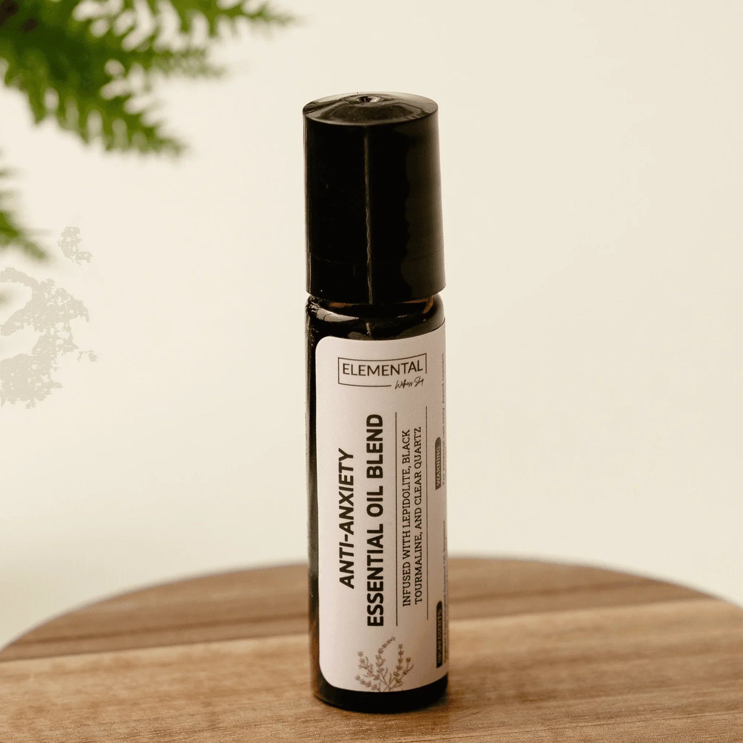 Anti-anxiety essential oil blend roller on wooden surface, natural aromatherapy product