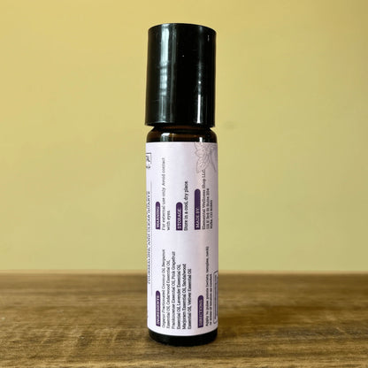 Natural anxiety relief essential oil roller with lavender label on wood surface
