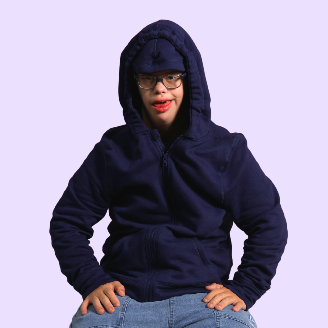 Person wearing a navy blue hoodie on a light purple background