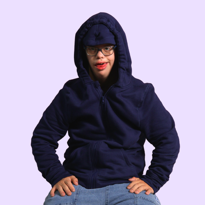 Person wearing a navy blue hoodie on a light purple background