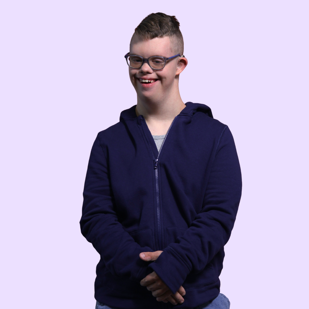 Person wearing a navy blue hoodie on a light purple background