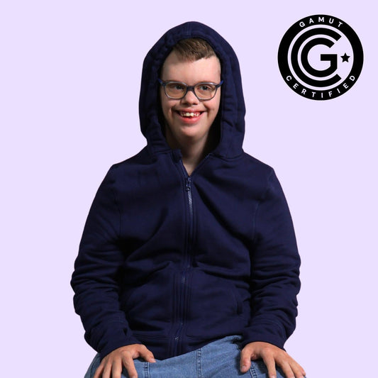 Person wearing a navy blue hoodie with a visible brand logo on a light purple background
