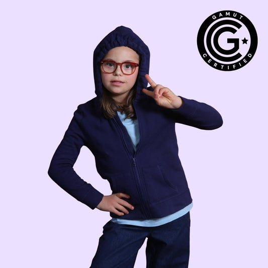 Child wearing a navy blue hoodie with a light purple background and Gamut Certified logo.