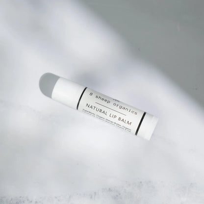 Natural lip balm tube with organic ingredients on a white background