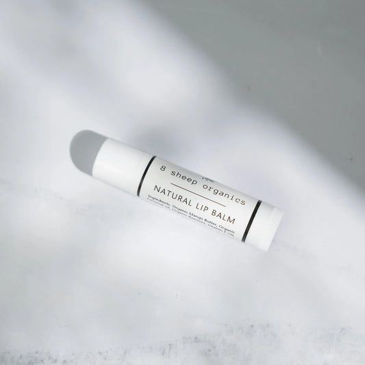 Natural lip balm tube with organic ingredients on a white background