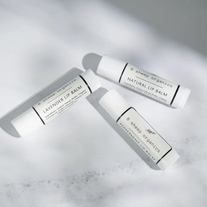 Three 8 Sheep Organics lip balm tubes—lavender, natural, and peppermint—on white surface.