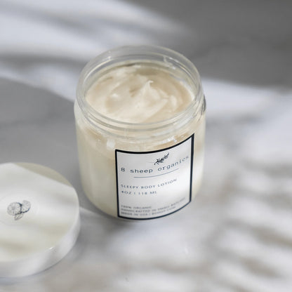 8 Sheep Organics Sleepy Body Lotion jar with creamy texture on marble surface