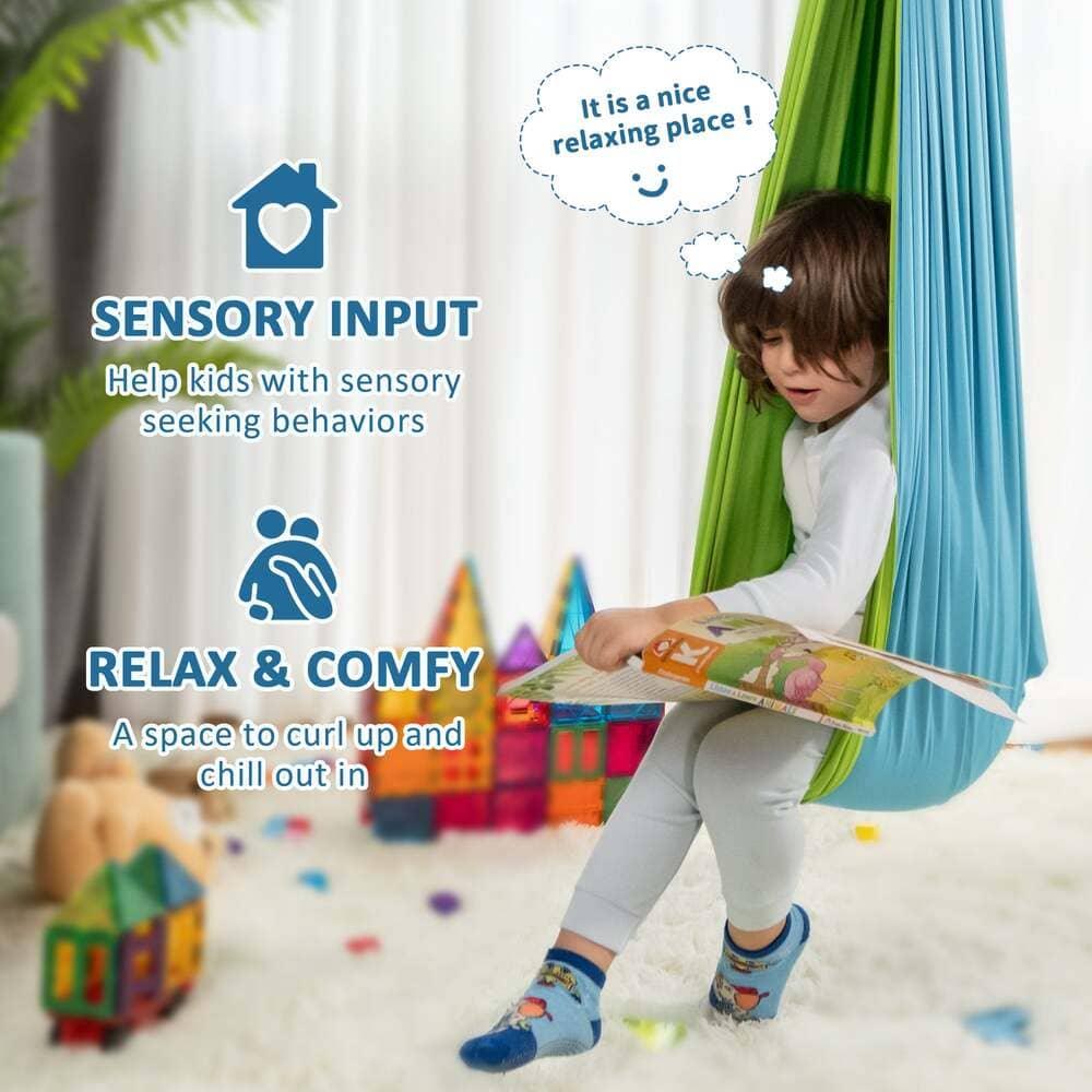 Child reading in sensory swing hammock in playroom, sensory input, relax and comfy.