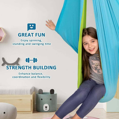 Girl sitting in a sensory swing hammock for kids, promoting strength, balance, and fun in a playroom.