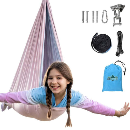 Smiling child in a pastel sensory swing with installation kit and blue storage bag