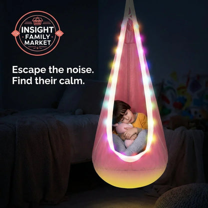 Child sleeping in a sensory pod chair with calming LED lights in a cozy bedroom