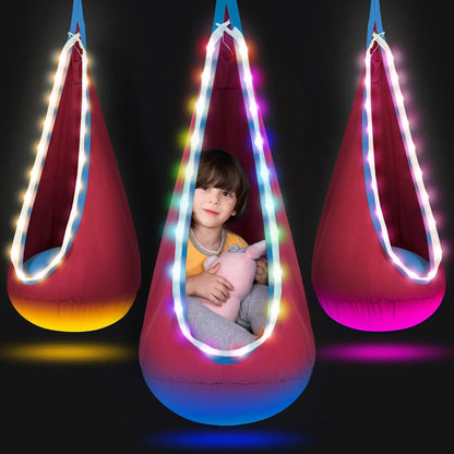Sensory pod swing for kids with LED lights, child sitting inside holding stuffed toy