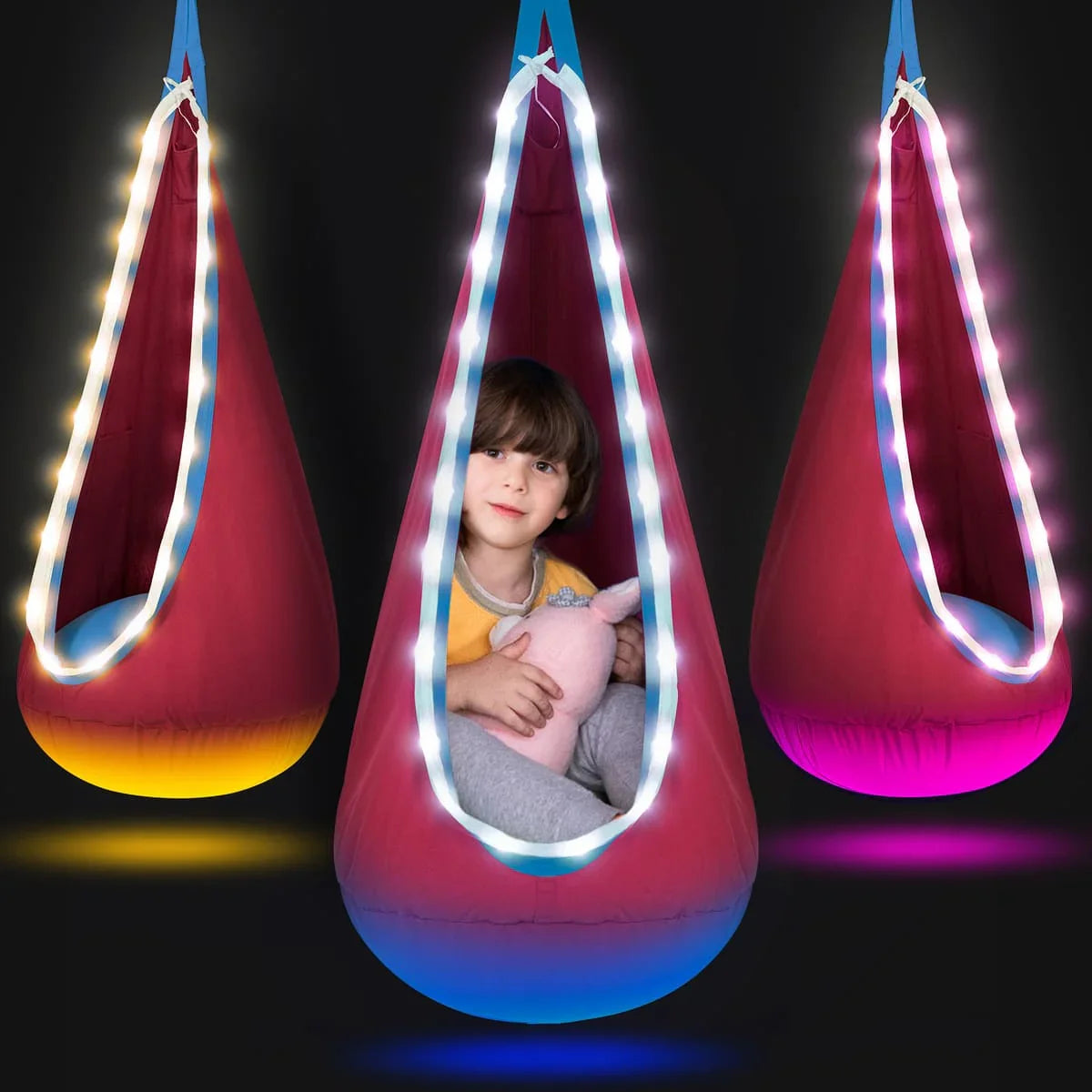 Sensory swing pod chair with LED lights, child inside holding plush toy, calming support