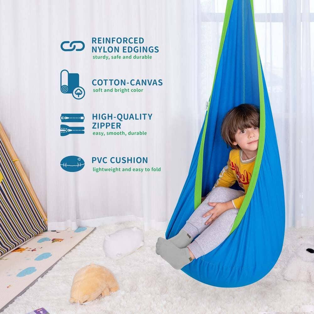 Child sitting in blue sensory swing pod, cotton-canvas indoor hammock with reinforced edging.
