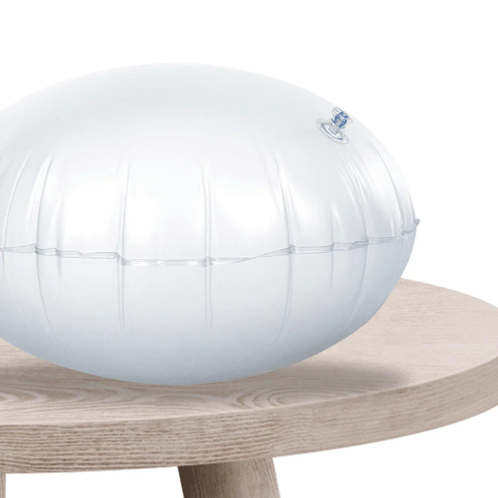 Clear inflatable sensory cushion on a wooden table, used for focus and balance support