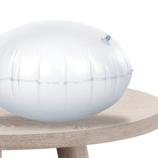 Clear inflatable sensory cushion on a wooden table, used for focus and balance support