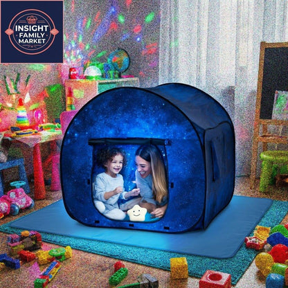 Parent and child in sensory-friendly dark blue tent with galaxy design in a playroom